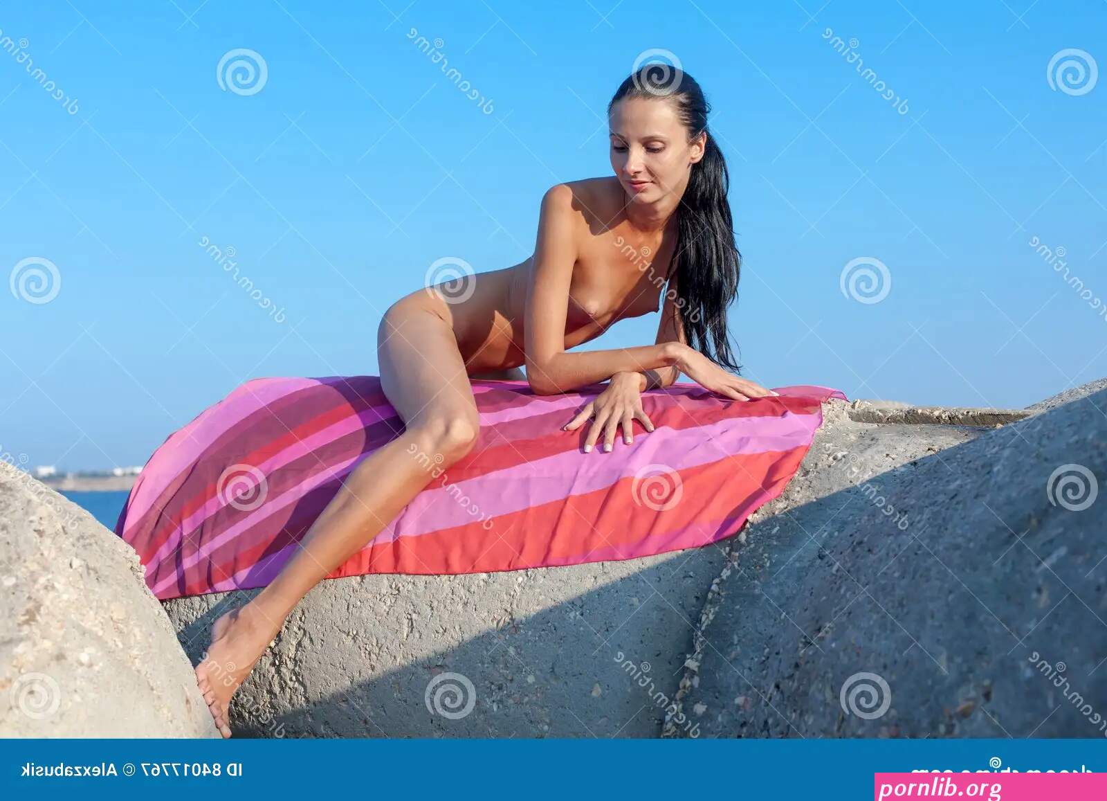 Naked Skinny Girl Sunbathing on Groyne Stock Image