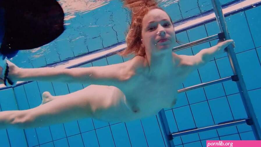 Teen girl Avenna is swimming in the pool