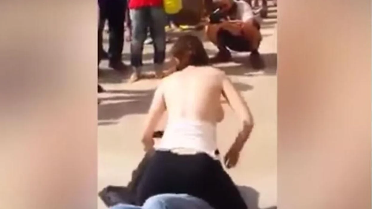Woman in Brazil publicly rubs her bare breasts on a mans face in bizarre anti-sexual harassment display