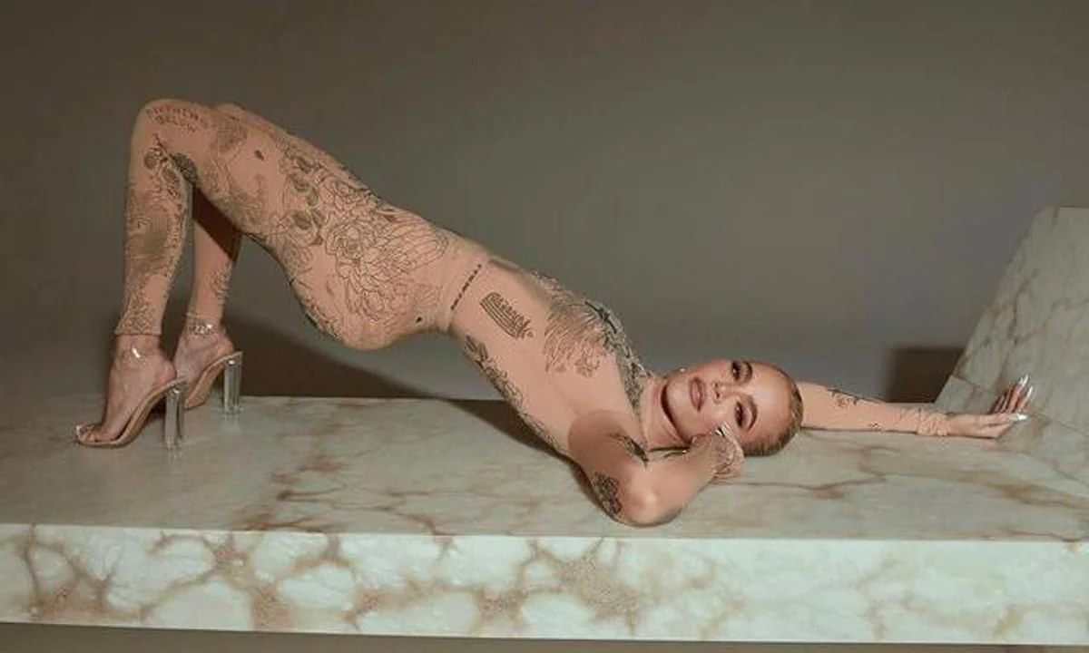 Khloé Kardashian shows off her flexibility in a nude body suit